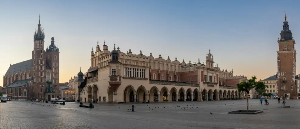 Main Market Square in Krakow with St. Mary's Basilica, the Cloth Hall, and the Old Town Hall Clock Tower